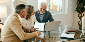 Couple learning when Medicare open enrollment is and reviewing plans.